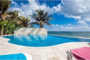 The enormous, stunning infinity pool looks out over the beach and ocean.