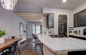 Kitchen with Gas Stove and Nespresso Machine.