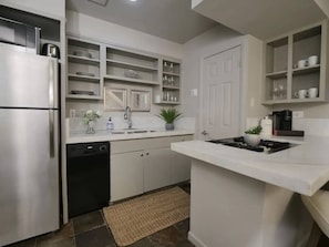 The kitchen is fully equipped with all the essentials and modern appliances, making it perfect for preparing meals with ease and convenience.