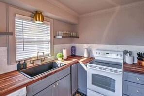 The kitchen is fully equipped with all the essentials and modern appliances, making it perfect for preparing meals with ease and convenience.