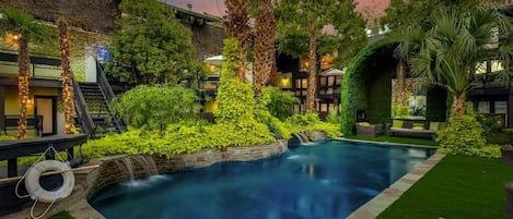 Courtyard pool with lush landscaping and fountain