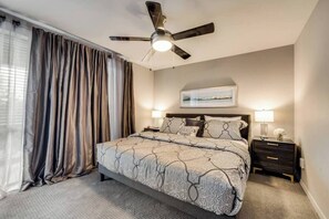 The primary bedroom, features a spacious king bed for a restful night’s sleep.