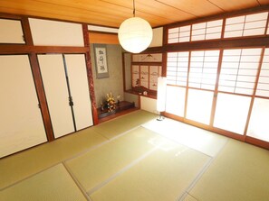 A large Japanese-style room with a bright porch behind the shoji screens