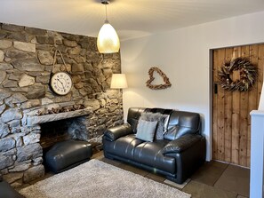 Cosy living area with original stone features.
