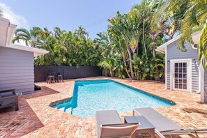 Relax in the sun and take a dip in the pool in the private backyard oasis