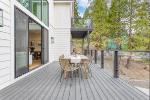 Huge sliding door connects the living room and deck for unique indoor/outdoor living.