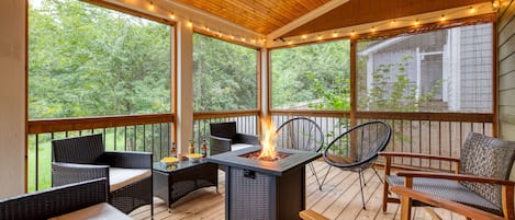 Spacious covered deck with a firepit and tons of seating.