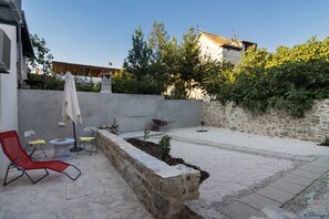 Private backyard with an outdoor furniture and outdoor shower.