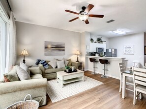 Cozy living room with modern decor and ample natural light.