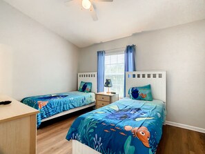 Cheerful bedroom with twin beds and colorful decor for a restful stay.