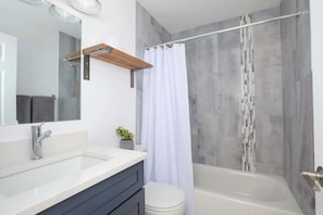 Full bathroom with various amenities 