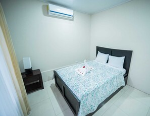 Bedroom 1: Double bed and roll away bed with A/C unit