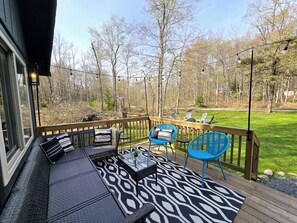 Lounge on the deck overlooking the forest views and firepit.