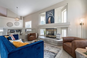 Bathed in natural light, the living room is reminiscent of conversation pits of the groovy good old days, with a step down into your intimate setting to gather