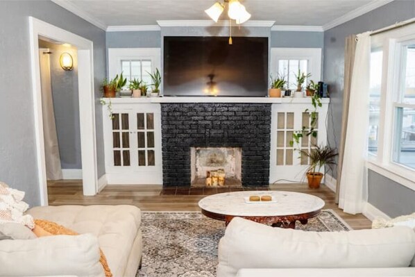 This space is perfect for relaxing. Cozy fireplace, plants and large smart TV.