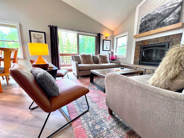 Great room with vaulted ceiling, gas fireplace and loads of sunshine
