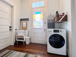 SHARED LAUNDRY CENTER WITH WASHER/DRYER COMBO AND IRON WITH IRONING BOARD