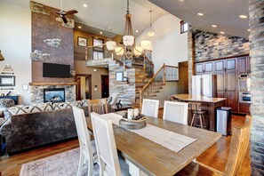 Relax in open living area with Mountain Views, fireplace and dining room