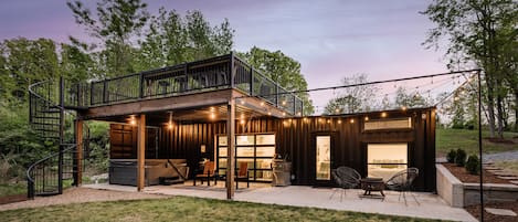 How could you go wrong with a hot tub, fire pit, string lights, and a winding staircase up to rooftop terrace?