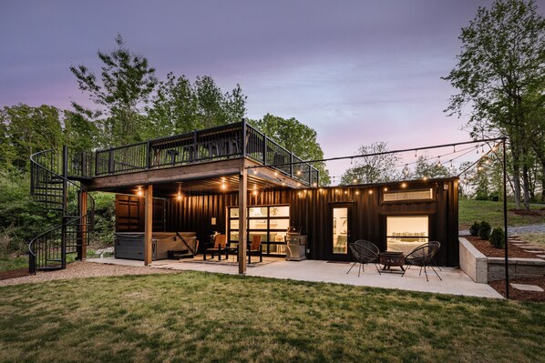 How could you go wrong with a hot tub, fire pit, string lights, and a winding staircase up to rooftop terrace?