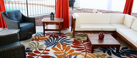 Cozy covered patio w/pull curtains to block late afternoon sun. Has solar lights