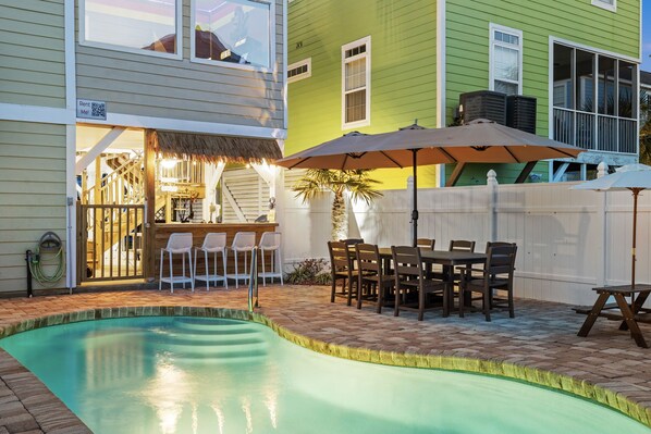 The poolside outdoor seating at twilight.