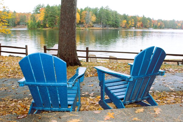 Relax in Adirondack chairs by the lake at your cabin.
