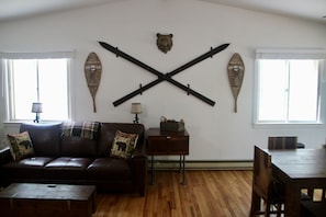 Living room wall shows vintage winter sports decor.