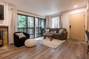 Living room with 360 swivel seat, live edge coffee table, & sleeper sofa