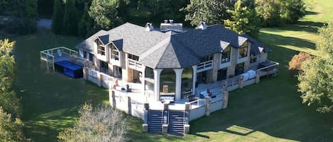 Expansive deck with heated pool, hot tub, bar top railings and grand center staircase