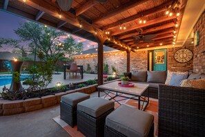 This covered patio offers plenty of comfortable seating with ceiling fans.