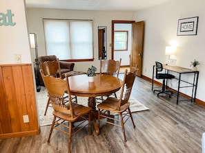 Dining room table with office desk and lounge chair perfect for reading a book!