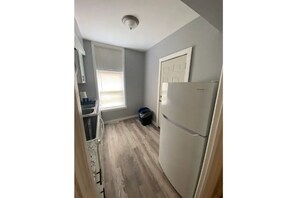 Kitchen with microwave, full size fridge, stove, toaster and Keurig coffee maker