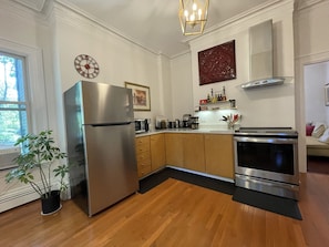 Kitchen: induction stove, quartz counters, multiple coffee and tea options