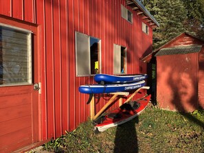 2 paddle boards and 1 single kayak with life jackets