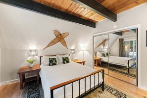 The downstairs bedroom is located right by the kitchen and is the closest to the bathroom. It has a queen size bed, a full size closet, plenty of lighting, a beautiful view of the back property, and more.