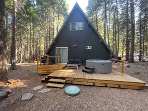 Enjoy the beautiful backyard deck with a hot tub and seating area. 