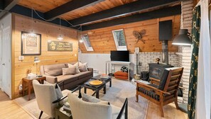 The downstairs living space is an open floor plan concept with the dining area and kitchen connected for optimal socializing. The skylights along the ceiling let in plenty of natural light. They have shades for added privacy.
