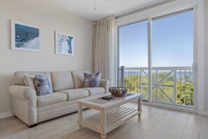 Living area with sleeper sofa and balcony access