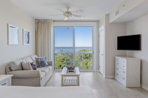 Living area with sleeper sofa and balcony access