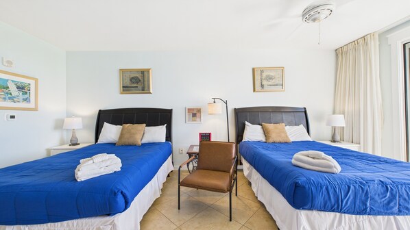 Two queen beds in common area with TV