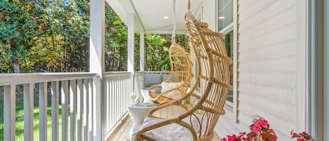 Relax and "hang out" on the covered front porch. Two hanging chairs and sofa