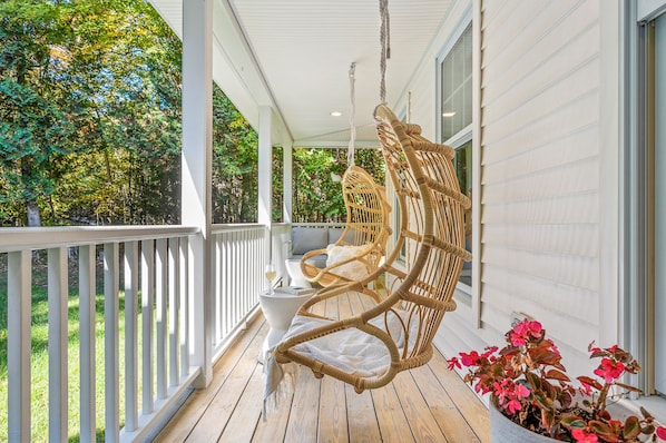 Relax and "hang out" on the covered front porch. Two hanging chairs and sofa
