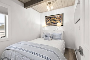 The condo offers a private bedroom with a queen bed and a pull-out sofa bed in the living room.