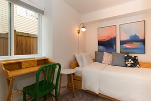 Colorful lower bedroom 3 with single bed and dedicated work space
