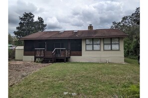 Back yard with patio and gas grill.