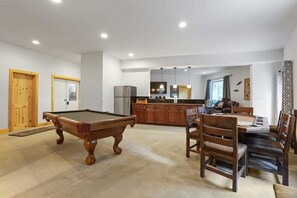 The basement includes a fabulous game room with a pool table, card table, wet bar, stainless steel refrigerator, and seats for as many as seven.