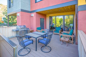 Main floor deck with BBQ and table for outdoor dining.