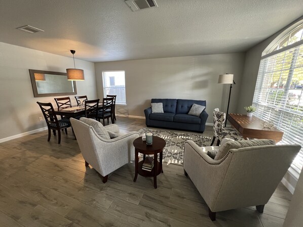 Bright and open living / dining space with lots of seating and work space.