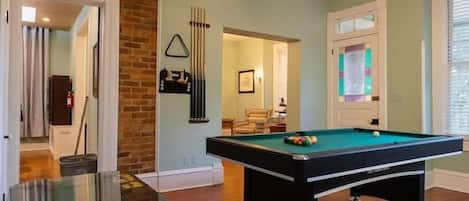 Incredible game room with a pool table, ping pong topper, and arcade machine!